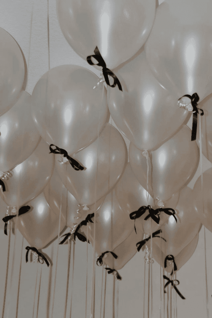 Bows attached to white balloons.
