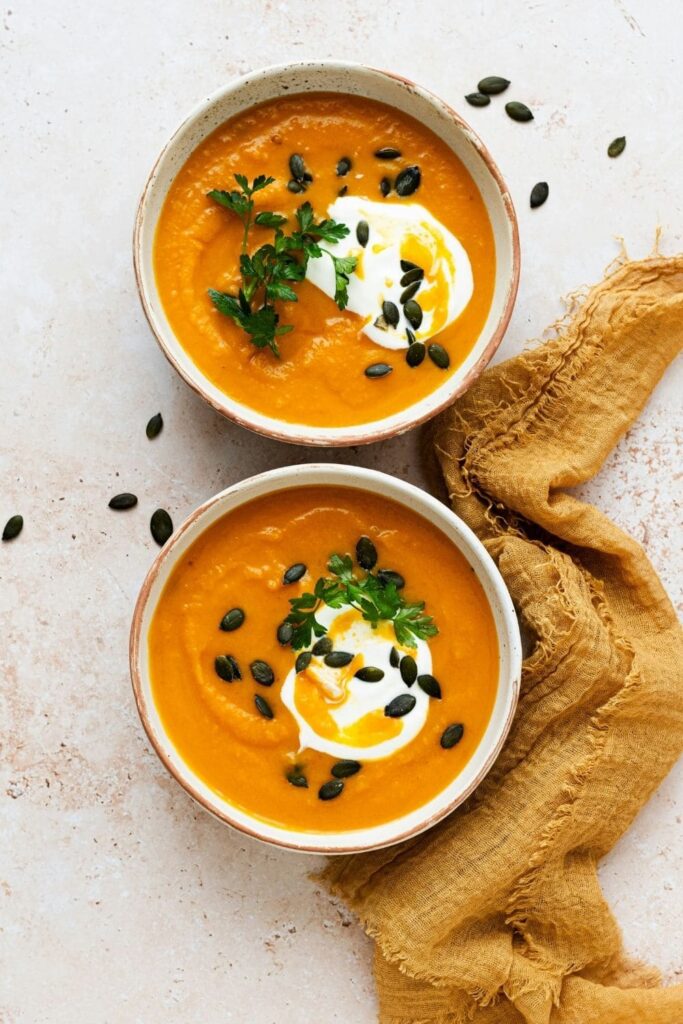 Two bowls of pumpkin soup.