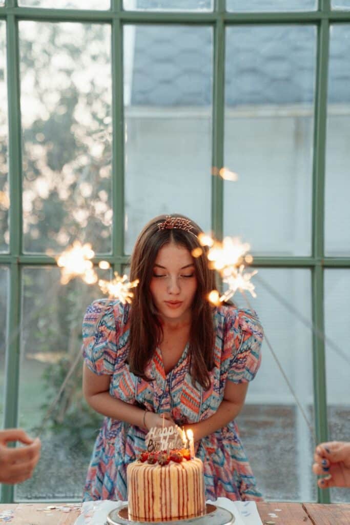 Woman blowing out birthday candles