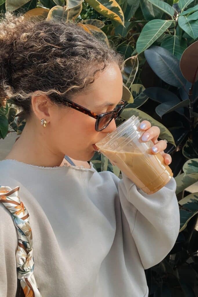 Woman sipping iced coffee